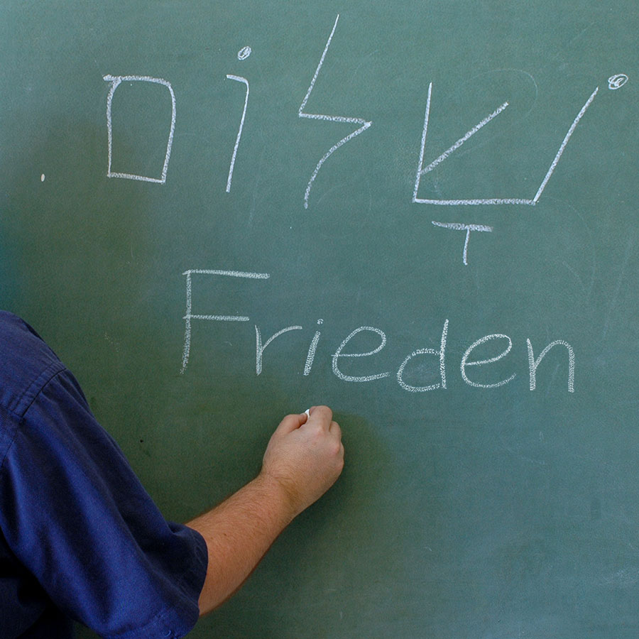 Hebräisches Wort „Schalom“ und „Frieden“ an einer Tafel